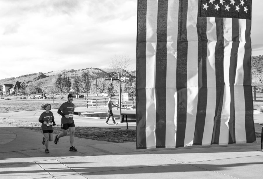 Clayton and Kim Bullock cross the finish line at National Veterans Day run at Spring Canyon Park on Sunday Morning. The proceeds from the race will go the Folds of Honor Foundation, which provides assistance to spouses and children of wounded and fallen service men.