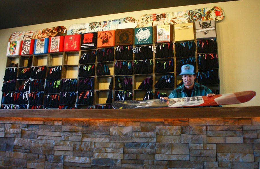 Brandon Woolridge inspects his personally designed snowboard at seventwentyeight outdoor. The new store features a variety of outdoor gear and even includes a study lounge in the store.