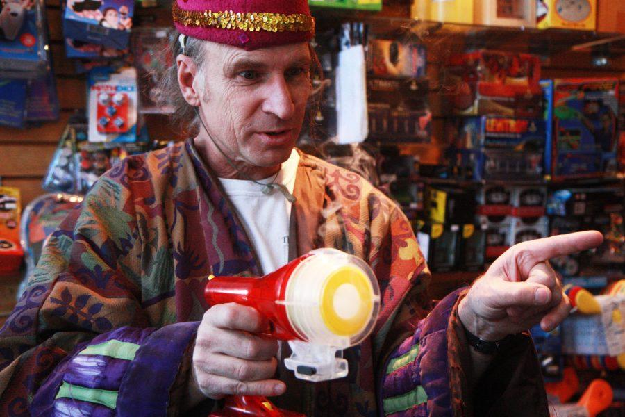 Owner of Science Toy Magic in Old Town Square, Matt Hannifin, plays with a toy gun that shoots puffs of vapor rings into the air. One of the many joys Hannifin reaps from his buisness is teaching his customers the fun science that makes the toys he sells so "magical".
