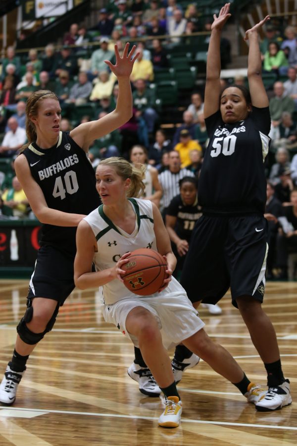 Guard Ellen Nystrom (13) searches for a pass late in the game against rival CU at Moby Arena last night. Nystrom had four points and nine rebounds in the loss to the Buffaloes.