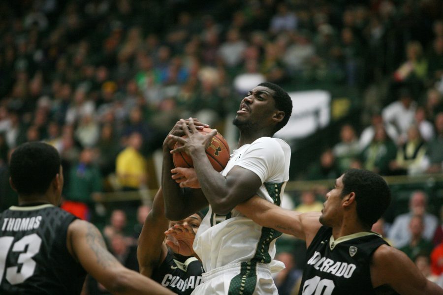 Gerson Santo (15) fights for the ball against CUs Josh Scott (40) during the Ram battle against the Buffs at Moby Tuesday night. The Rams 67-62 lost despite having a four point lead at the half.