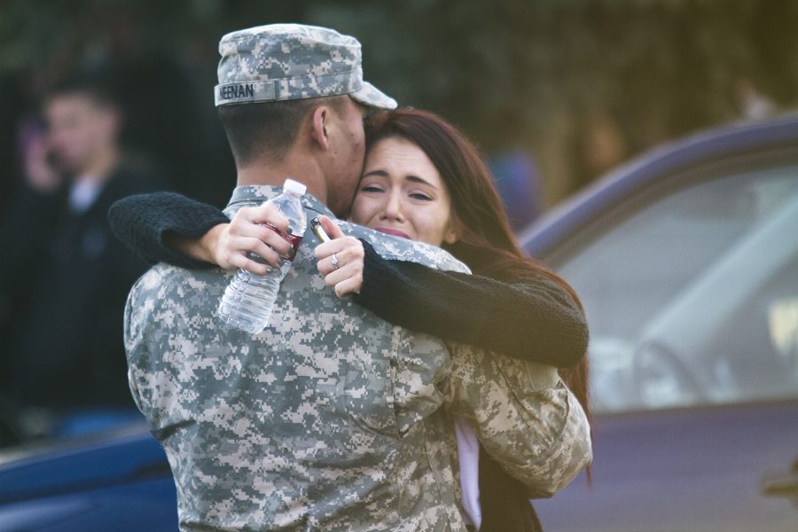 A soldier greets a female student who attends Arapahoe High School whom he has some relationship with a couple of hours after the shooting. Evacuated students waited at Shepard of the Hills Lutheran Church for parents or relations to come pick them up.