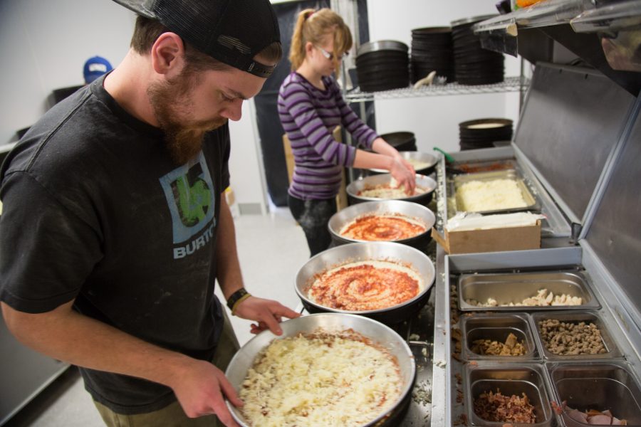 Krazy Karls manager Jeremy Dill prepares pizzas for the nights deliverys yesterday afternoon. Krazy Karls, located at Elizabeth and Shields, is a local favorite for late night pizza.