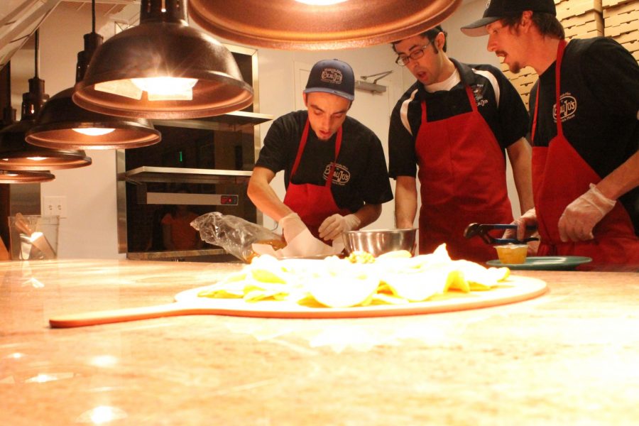 Line cooks Zach Ohmie, Victor Romero, and Nate Hodson prepare a nacho dish on Beau Jos opening night Monday. The opening was a success according to Operations Manager Michelle Priola.