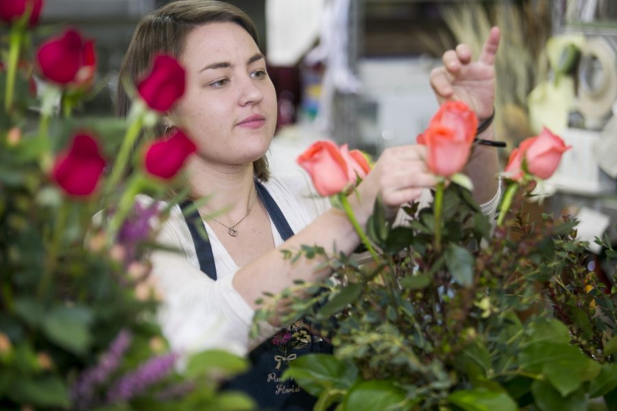 Krystal Kappeler, first year master's candidate in horticulture, arranges flowers for Valentine's Day at Paul Wood flower shop in Old Town. Many of Paul Wood's flowers come from Latin, South America, or Hawaii.