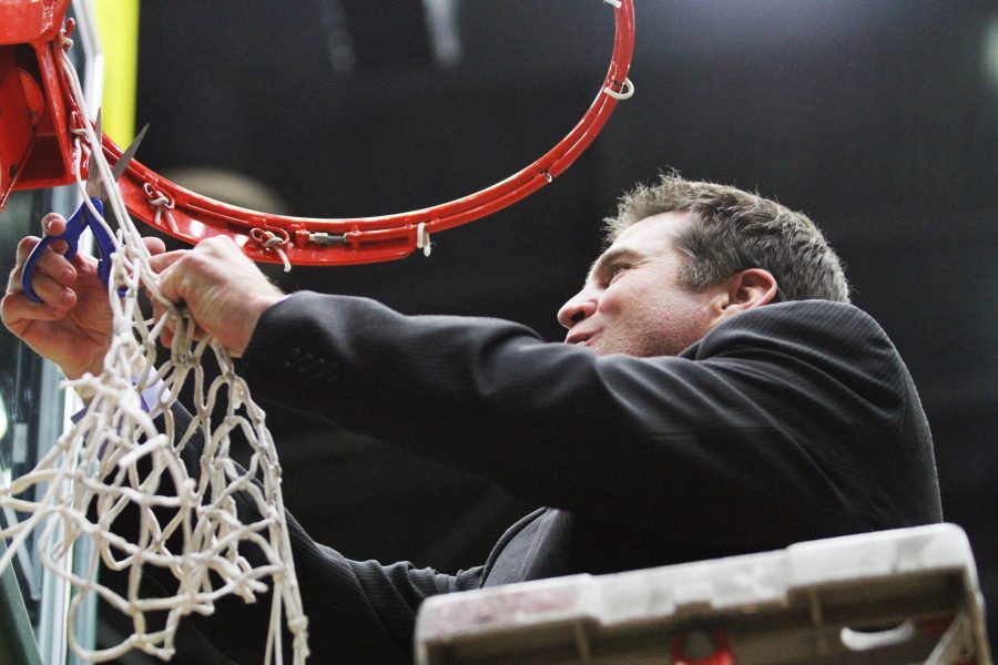 CSU Women's Basketball Head Coach Ryun Williams cuts down the rest of the net at Moby after the Ram win against UNLV Wednesday night. The CSU win and Boise State loss clinches the regular season Mountain West conference title for the Rams.
