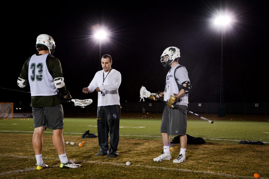 Assistant coach Brennan Rachman works with the face-off unit during practice Monday night. The Rams Lacrosse team will face-off against Grand Canyon February 21st in California.