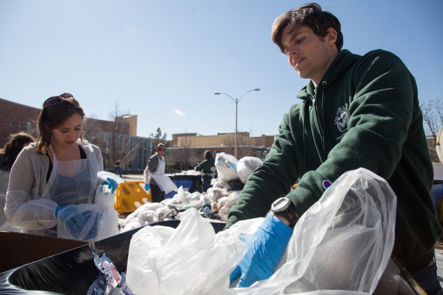 Housing and dining sustainability coordinator Tim Broderick seperates waste during yesterdays waste audit in the Plaza. The annual event acts as a visual message showing passing students a faulty how much of the on campus trash can actually be composted and recycled.