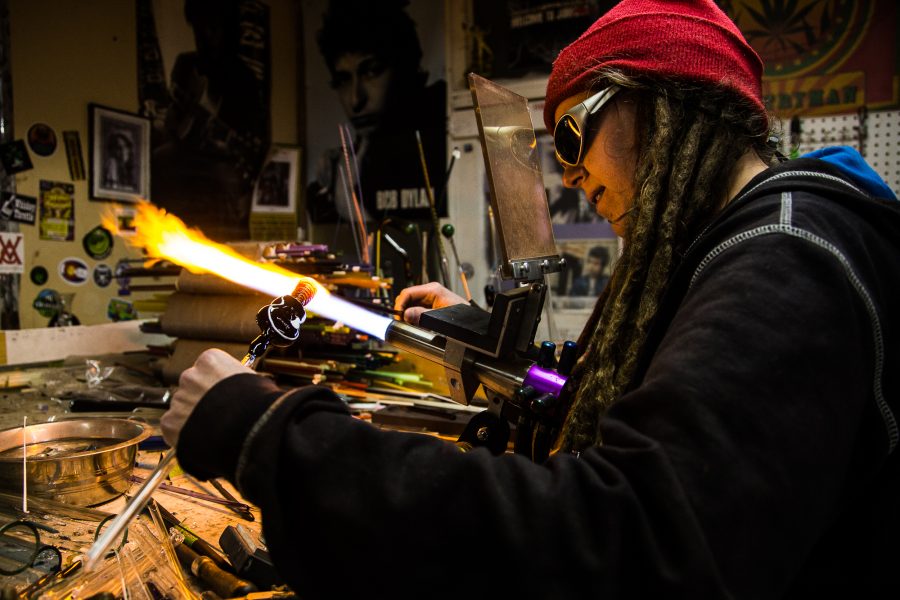 Theresa Nortan, a co-owner of Glass Antixx, crafts a glass guitar at her studio Tuesday afternoon. Glass Anitxx specializes in glass art, and is located in Fort Collins.