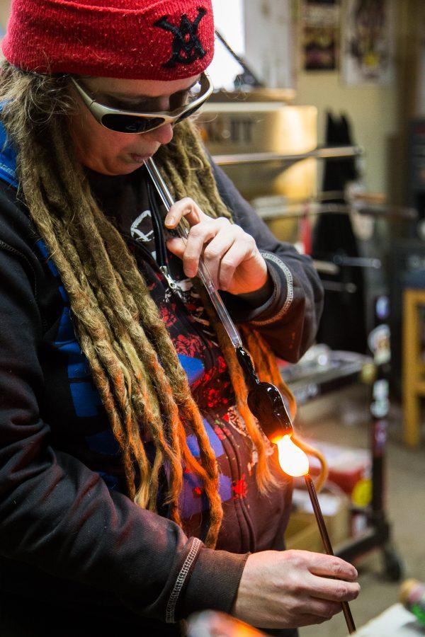 Theresa Nortan, a co-owner of Glass Antixx, crafts a glass guitar at her studio Tuesday afternoon. Glass Anitxx specializes in glass art, and is located in Fort Collins.