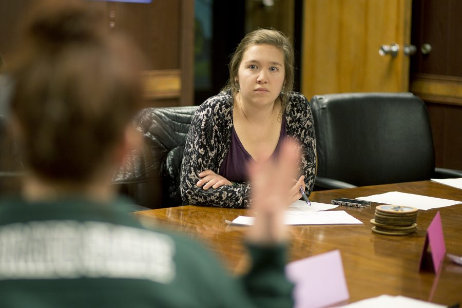 Courtney Naumann, assistant director of environmental affairs, listens to Lexi Evans discuss the format of debates at a meeting discussing campaigning issues that have occured.
