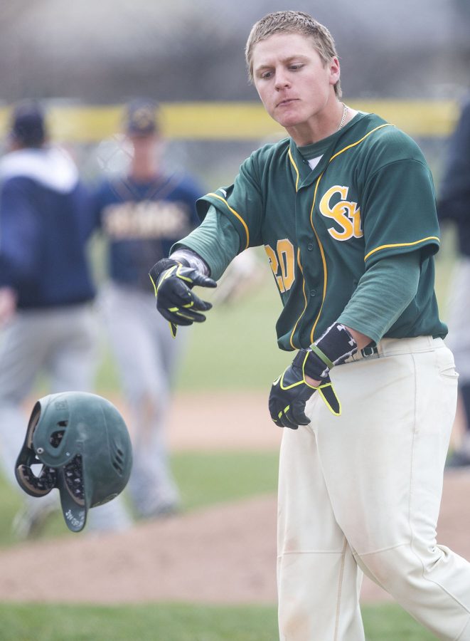 CSU's Mike Medina, 20, throws his helmet down in frustration after hitting a pop-fly that was caught while bases were loaded to end their game against UNC Sunday afternoon. The Rams lost 9-7.