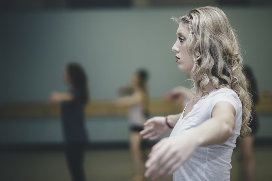 Madison Lobato warms up before rehearsal for the dance major capstone, Interlace, Thursday night in the UCA. Although the capstone was the work of four seniors, many other dancers accompanied them to make their concert come to life.