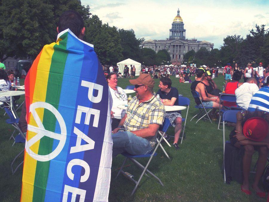 PrideFest attendees relax at Civic Center Park, in front of the Capitol building.
