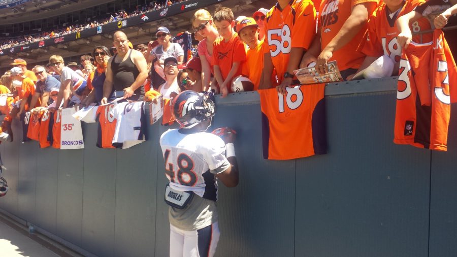 Former CSU linebacker Shaquil Barrett (48) signing autographs for Broncos after Denvers scrimmage at Sports Authority Field on Saturday Aug. 2, 2014.