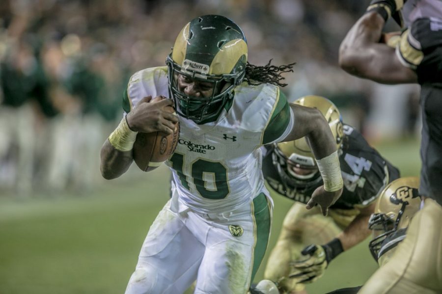 Colorado State running back Dee Hart (10) breaks through the tackle of Colorado linebacker Addison Gillam during Friday's Rocky Mountain Showdown.