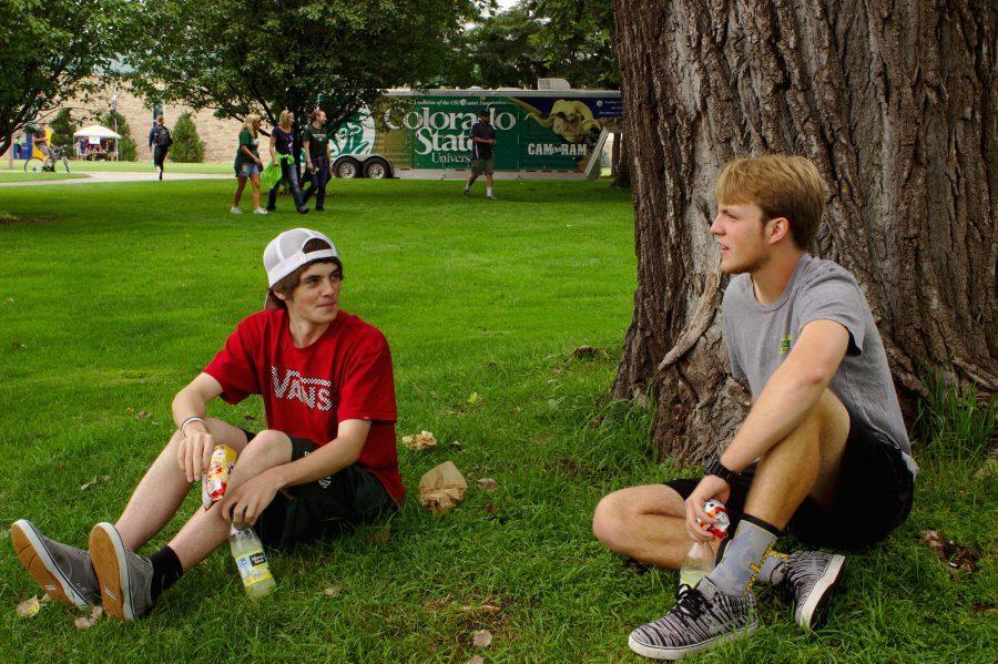 (right to left) Freshmen Webb Kimmel and J.P. talk under a tree on the corner of West Plum Street and Meridian Avenue at Grill The Buffs