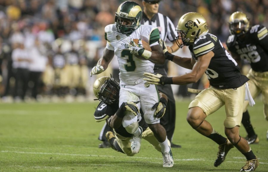 Colorado State running back Treyous Jarrells (3), runs through a CU defender's tackle during the 2014 Rocky Mountain Showdown. (Austin Simpson/Collegian) 