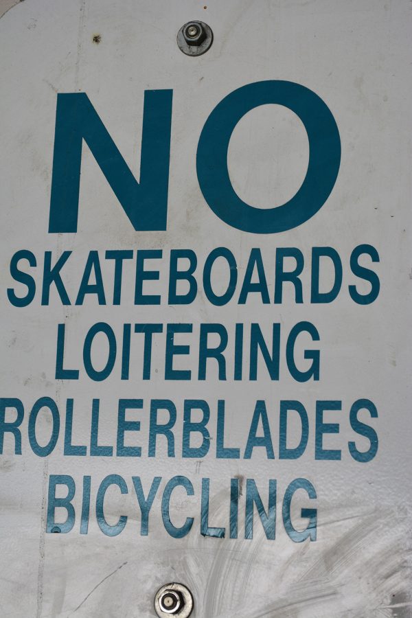 Signs advising against loitering line some Fort Collins buildings. Fort Collins Police will take action if necessary. (Photo Credit: Megan Fischer)