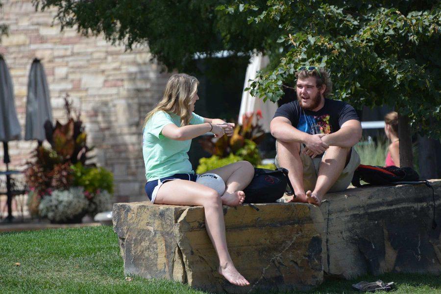 Kelly Scharlau, a sophomre majoring in biomedical engineering and Tyler Parker, a freshman majoring in biomedical engineering, talk outside the Student Recreation Center before meeting some other friends to play a game of volleyball. (Photo Credit: Megan Fischer)