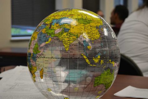 A globe sits on the table at the front of the INTO CSU classroom. It was used for an activitiy at the beginning of the class in which international students and the Conversation Partners introduced themselves. (Photo Credit: Megan Fischer)