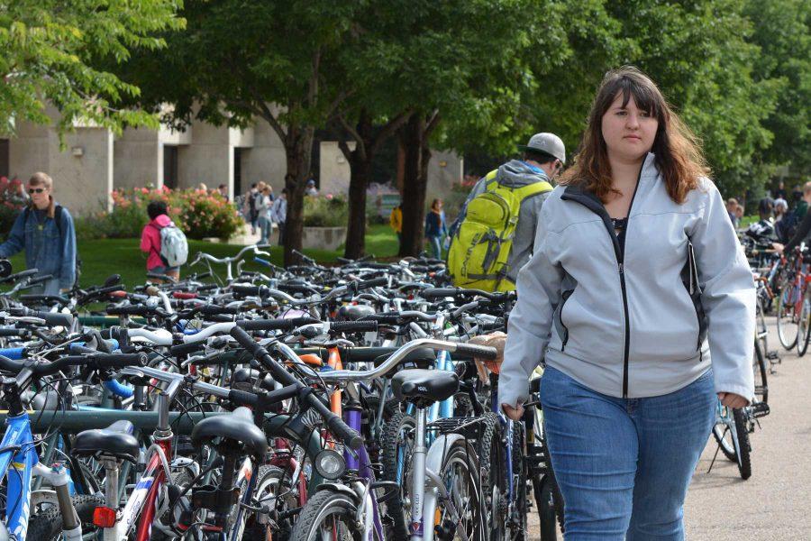 Senior hospitality management major, Rachel Inman walks by just some of the many bikes on campus. Inmans bike was stolen in fall 2013, but it was returned because it was registered through CSUPD. (Photo Credit: Megan FIscher)