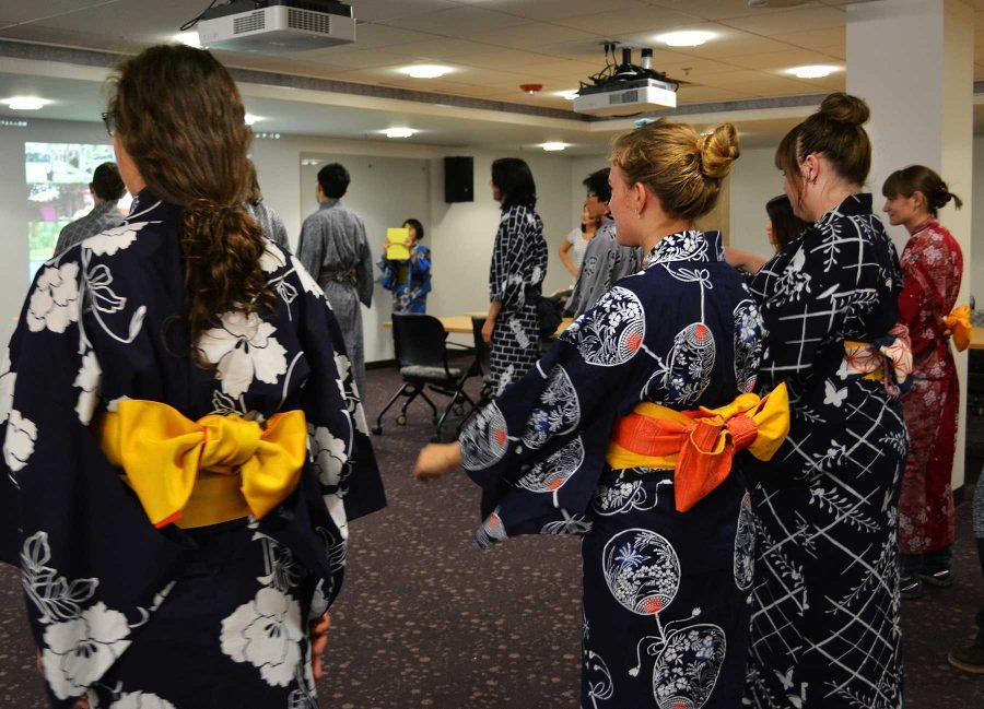CSU students stand and listen to the dance instructions at the Japanese Bon Dance today at Morgan Library. The dance usually takes place around August or September, and the students are wearing traditional cotton Summer Kimonos.