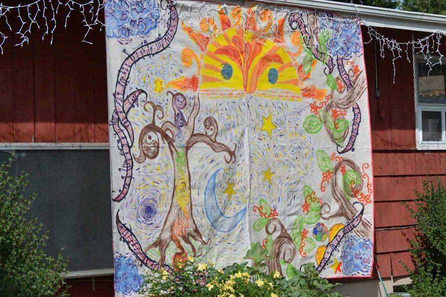 A mural designed specifically for the Xaniscape Festival hangs from the side of the building. Members of the Geller Center and members from Juiced on Imagination created teh mural for the festival. (Photo Credit: Megan Fischer)