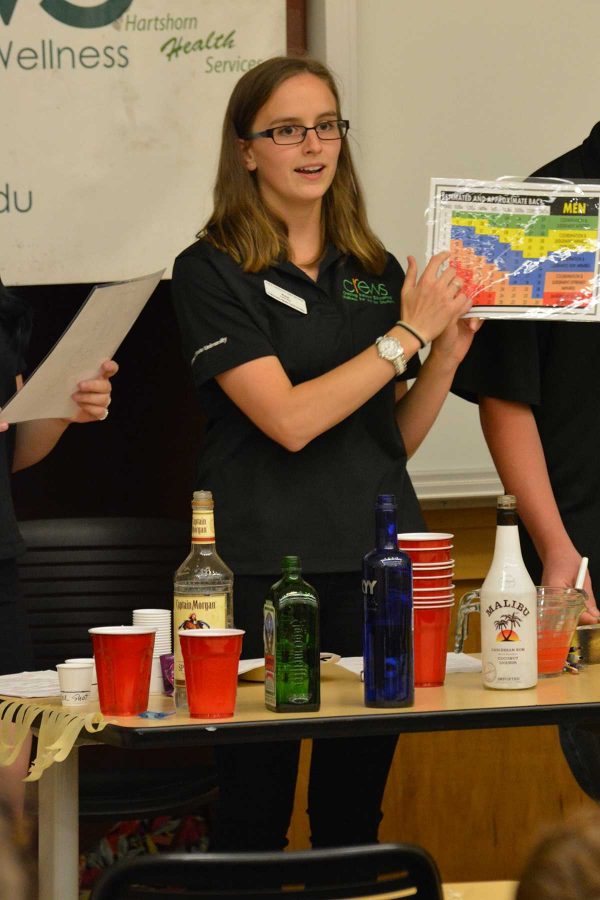 Psychology junior, Anastasia Soroka, shows participants of a CrEWS meeting a blood alcohol chart for males as a part of a teaching senario. (Photo Credit: Megan Fischer)