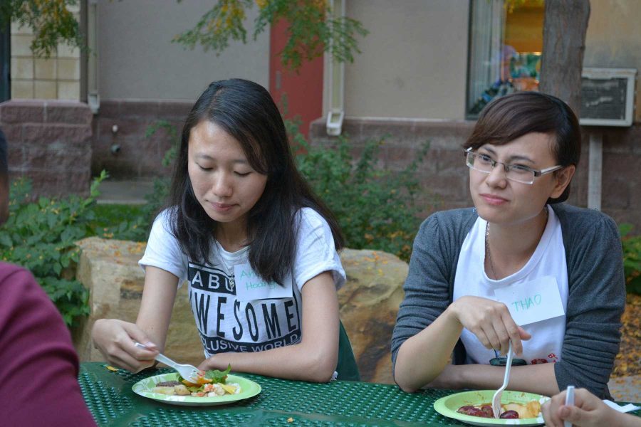 Economics seniors, Ahn Ngoc Tram Hoang and Thao Nong, enjoy eating and talking with thier friends and community members at the Friday Afternoon Club. (Photo Credit: Megan Fischer)