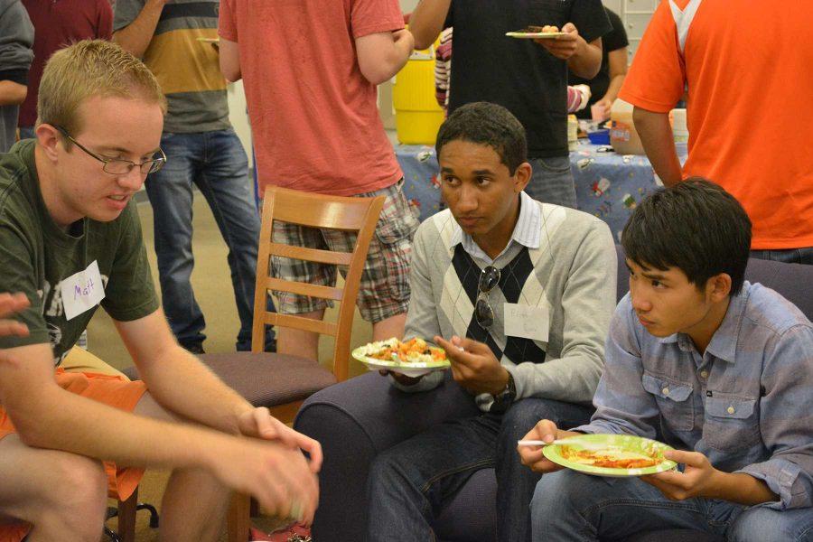(From left) Natural Resource Recreation and Tourist Management senior, Matthew Sill, INTO student Edson Costa, and civil engineering graduate student Chenda Deng enjoy thier meal and talk with each other at the Friday gathering. (Photo Credit: Megan Fischer)