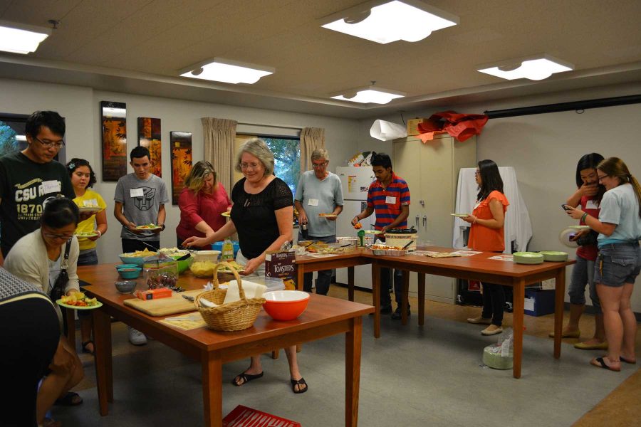 Students and community members enter into the kitchen to get food and then head out to enjoy talking with one another at the Friday Afternoon Club. (Photo Credit: Megan Fischer)