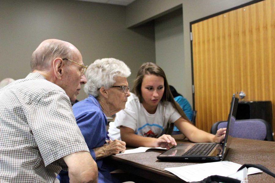 Senior human development and family sciences major Ashley Liljeros shows Bill and Dorothy Eiman a trick or two on their computer. Dorothy Eiman is a CSU alumni. 