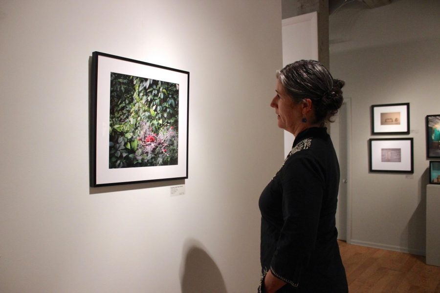 Executive director of The Center for fine Art Photography, Hamidah Glasgow, observes one of her favorite pieces in the still life exhibit on Thursday afternoon. The exhibit will be running until Saturday, Sept. 27.