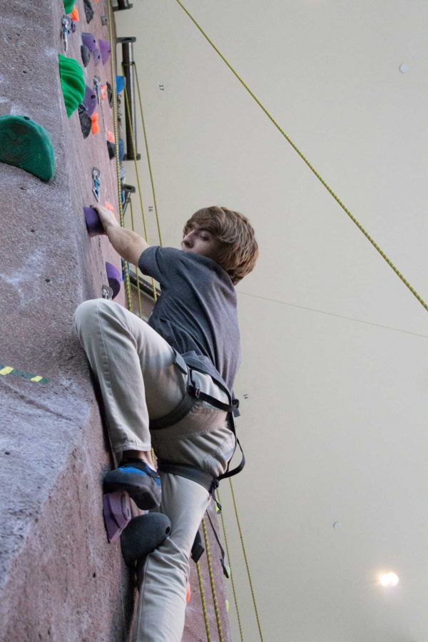 Derek Peterson, a junior biology major, practices his climbing skills at the CSU Rec Center Climbing Wall. (Photo by Joe Tiner)

