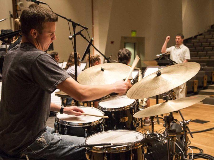 Senior music major and drummer, Keller Paulson, rehearses on Tuesday night in the University Center of the Arts. (Photo credit: Eliot Foust)
