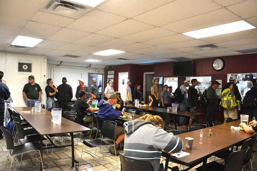 The homeless and less fortunate wait in line for dinner in the dining room at the Fort Collins Rescue Mission on Tuesday, September 9. According to Stephanie Polzin, kitchen supervisor at the Fort Collins Rescue Mission, the FCRM has been serving nearly 200 more homeless citizens each night than last year. (Photo credit: Danny Bishop)