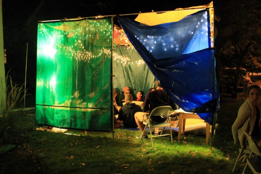 Students from all backgrounds eat and converse inside Sukkah at Hillel Center during the Bedouin Hospitality Night 