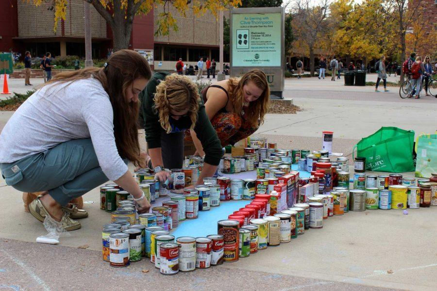 Members of the Warner College of Natural Resources College Council team Rachel Baiyor, sophomore ecosystem sciences and sustainability major; Rylee Meyer, junior natural resource management major and Julie Lipson, freshman natural resources recreation and tourism major help construct the Patagonia fish for their structure on Wednesday. 