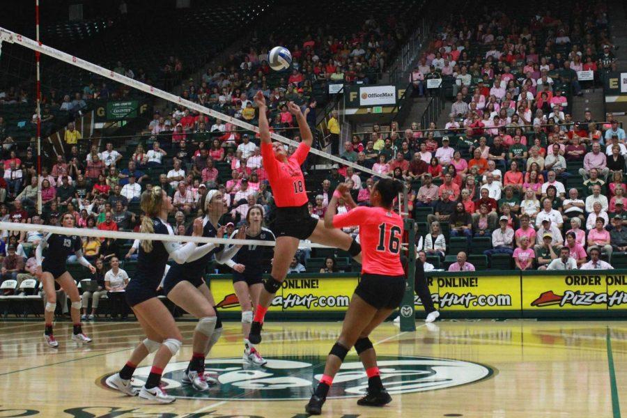 Setter Deedra Foss (18) jumps to set the ball for middle blocker Jaliyah Bolden (16) during the first set of Saturdays Pink Out game against Utah State at Moby Arena.