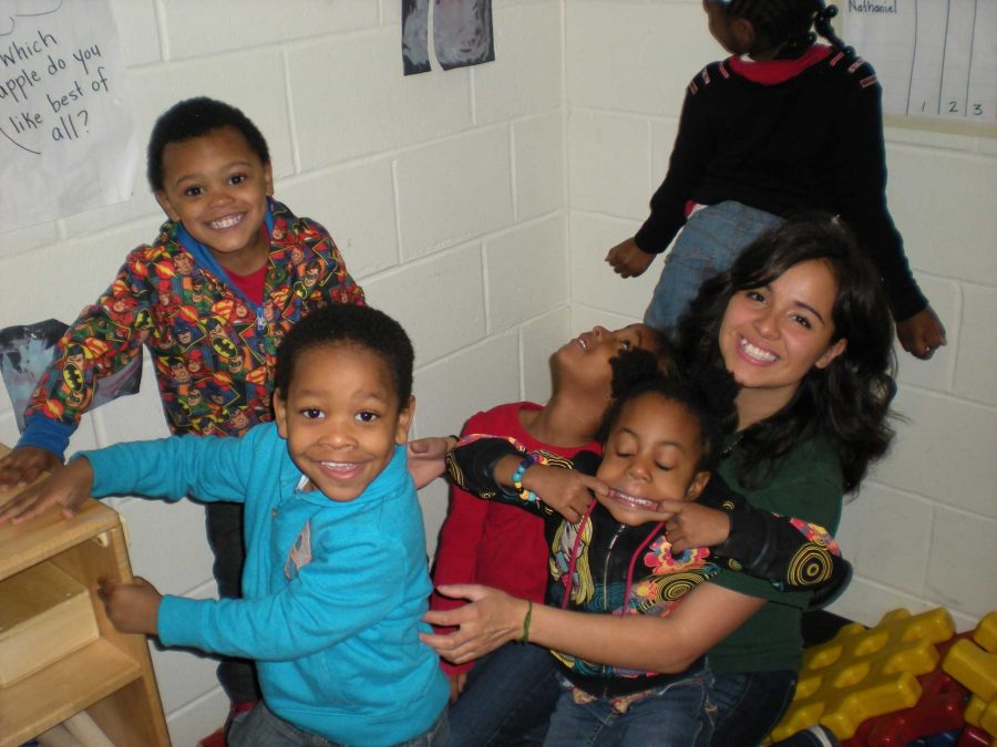 Site leader and CSU veterinary medicine student Bianca Alba works with some of the children in Kansas City last spring. The kids are apart of Operation Breakthrough, a group dedicated to helping children living in poverty. (Photo credit:Caite Plunkett)