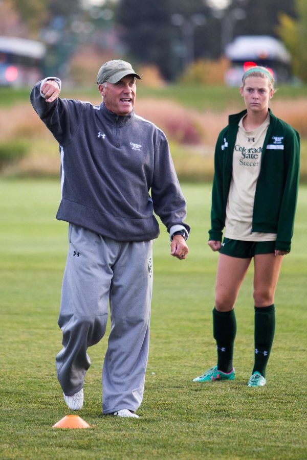Coach Bill Hempen gives instructions for a passing drill at practice on Wednesday morning. (Photo credit: Eliot Foust)