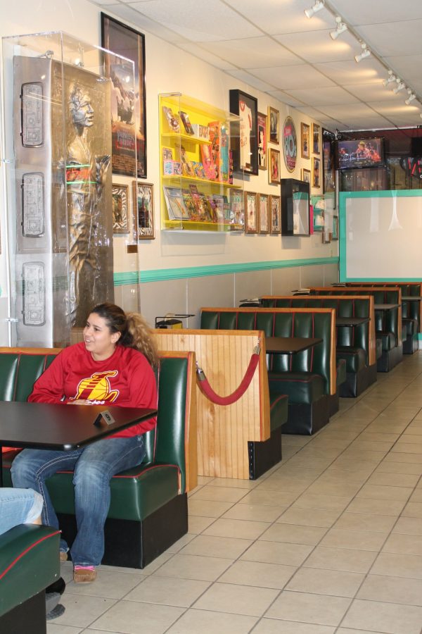 Local resident Mariah Martin waits for her order surrounded by 80s decor and a frozen Han Solo sculpture behind her at Totally 80s Pizza. (Photo credit: Sarah Fish)