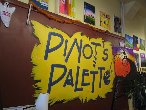Besides adorning the walls with ghosts, spiderwebs and other Halloween decor, Pinot Pallette is displaying spooky halloween-themed paintings. (Photo credit: Caitlyn Berman)