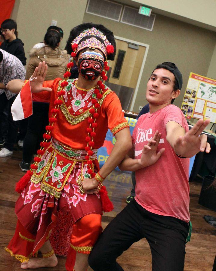 Tales Costa, a junior biomedical sciences student, dances with a traditional Indonesian dancer. Photo courtesy of Zara DeGroot.