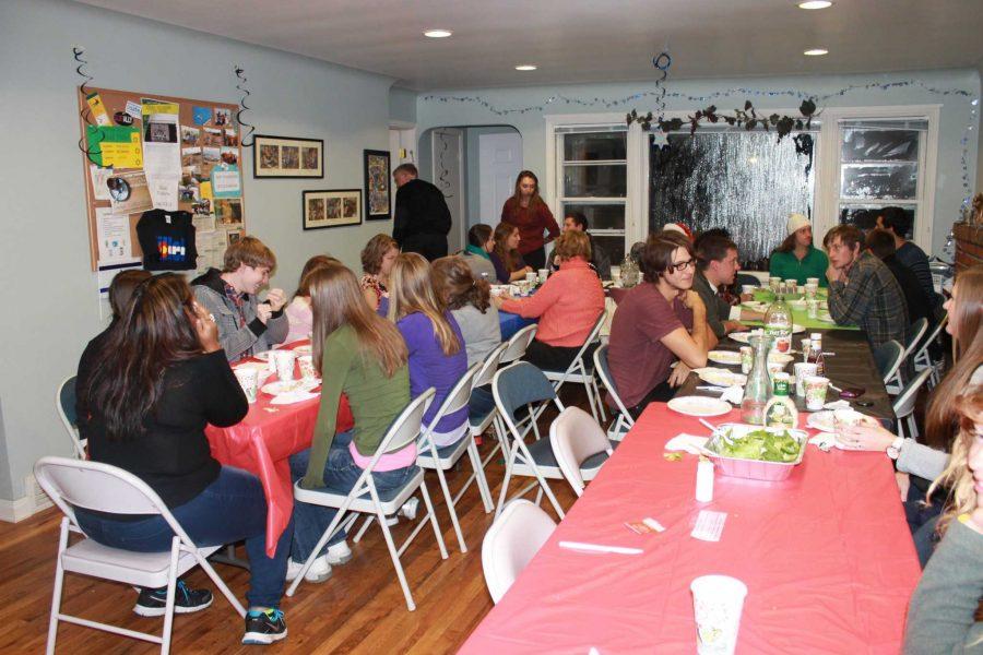 Students and community members gather round the table for interfaith discussion in celebration of Thanksgiving at Hillel Center. 