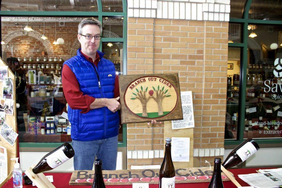 Aaron Fodge, partner of Branch Out Cider, shows off the wood work while at the Winter Farmers Market on Saturday at the Opera Galleria. This seasons batch of hard cider will be served at Scrumpys restaurant in downtown Fort Collins. (Photo Credit: Christina Vessa)