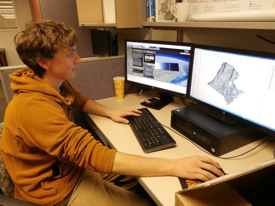 Senior natural resource management major Erick Kelly works with the mapping software in the Geospatial Centroid in the library. (Photo credit: Sady Swanson)