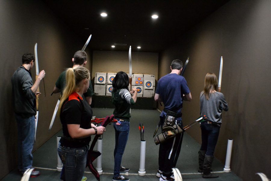 Archery club president Blaise Newman lines up club members to practice their accuracy. (Photo credit: Maria Nateras)