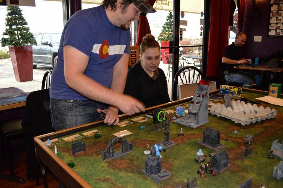 Joshua Bianchi and Kara Pounds play a game at the Haunted Game Cafe. (Photo credit: Stephanie Mason)